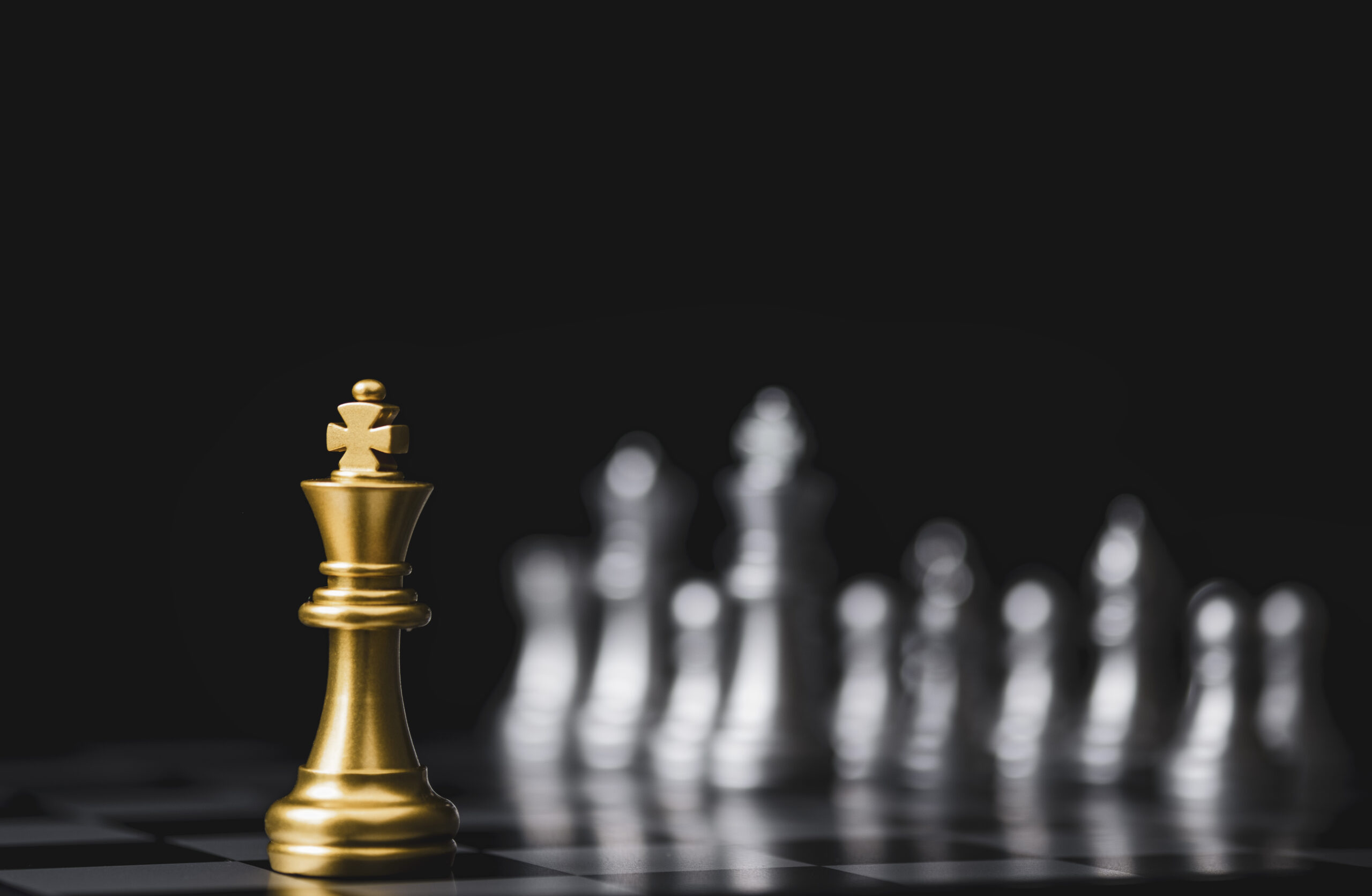 Leadership Training symbolized by gold colored king on chess board